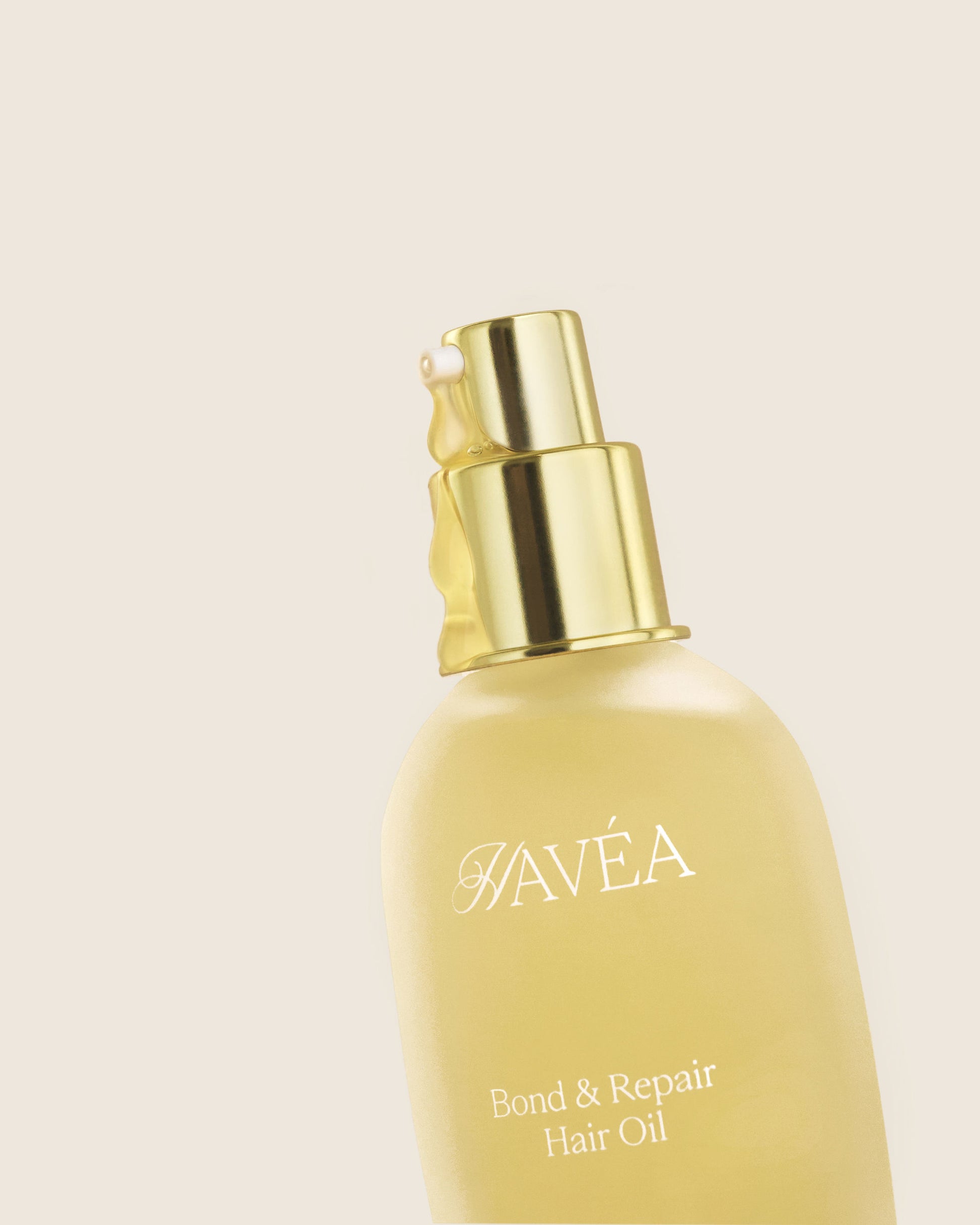 Havéa bond & repair hair oil bottle on a beige background