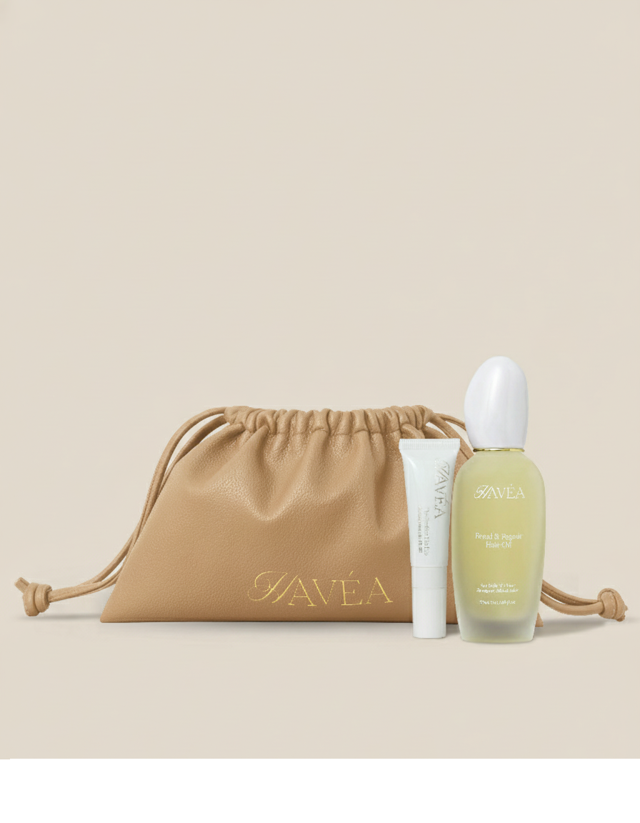 Hair and lip care products including a bottle and tube with a tan drawstring bag on a beige background.